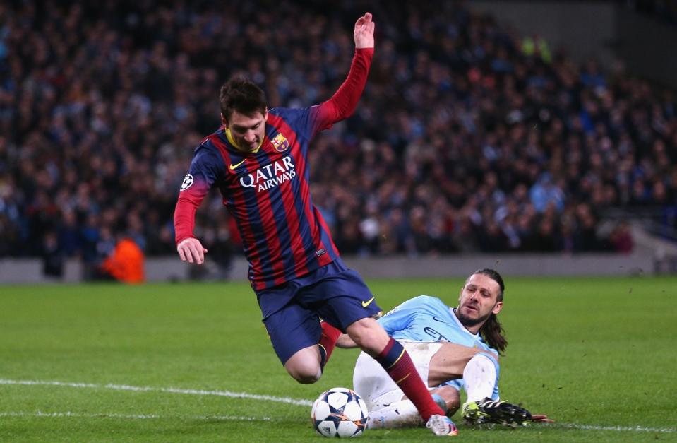 Martin Demichelis of Manchester City fouls Lionel Messi of Barcelona to concede a penalty and is subsequently sent off during the UEFA Champions League Round of 16 - GETTY IMAGES