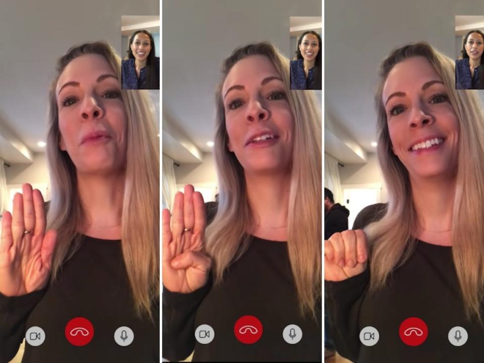 A woman enacts the "signal for help" hand gesture while talking to a friend on their cell phone. The “signal for help” hand gesture was created by the Canadian Women’s Foundation in 2020, anticipating domestic violence victims may need to use it during quarantine.