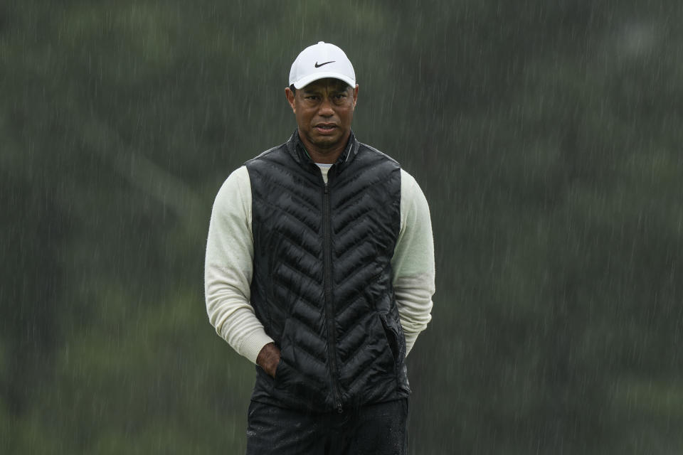Tiger Woods walks on the 18th hole during the weather delayed second round of the Masters golf tournament at Augusta National Golf Club on Saturday, April 8, 2023, in Augusta, Ga. (AP Photo/Charlie Riedel)