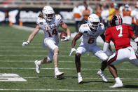 Texas wide receiver Brenden Schooler carries the ball after a reception during the first half of an NCAA college football game against Texas Tech, Saturday Sept. 26, 2020, in Lubbock, Texas. (AP Photo/Mark Rogers)