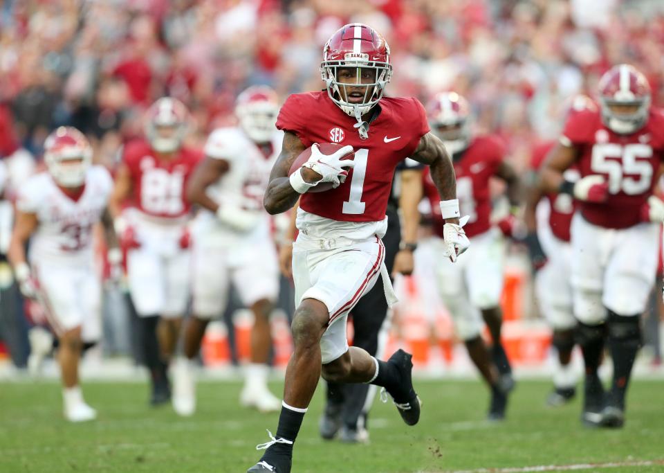 Nov 20, 2021; Tuscaloosa, Alabama, USA;  Alabama wide receiver Jameson Williams (1) runs to the end zone for a touchdown after catching a pass from Alabama quarterback Bryce Young (9) as the Crimson Tide played Arkansas at Bryant-Denny Stadium. Mandatory Credit: Gary Cosby Jr.-USA TODAY Sports