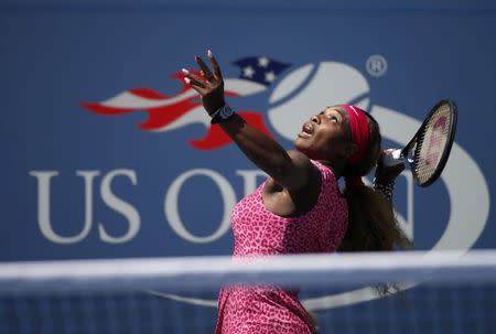 Serena Williams of the U.S. serves to compatriot Vania King at the 2014 U.S. Open tennis tournament in New York, August 28, 2014. REUTERS/Mike Segar