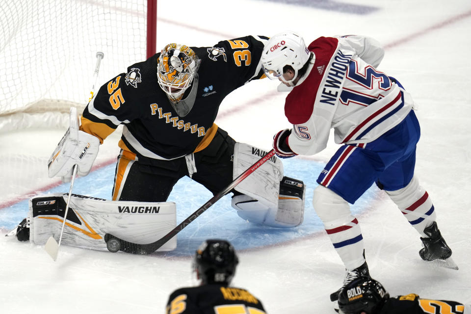 Montreal Canadiens' Alex Newhook (15) can't get a shot past Pittsburgh Penguins goaltender Tristan Jarry during the first period of an NHL hockey game in Pittsburgh, Thursday, Feb. 22, 2024. (AP Photo/Gene J. Puskar)