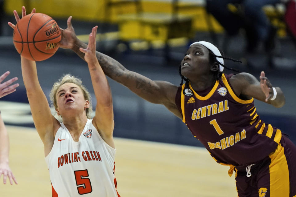 Bowling Green's Elissa Brett (5) and Central Michigan's Micaela Kelly (1) battle for a loose ball during the second half of an NCAA college basketball game in the championship of the Mid-American Conference tournament, Saturday, March 13, 2021, in Cleveland. Central Michigan won 77-72. (AP Photo/Tony Dejak)