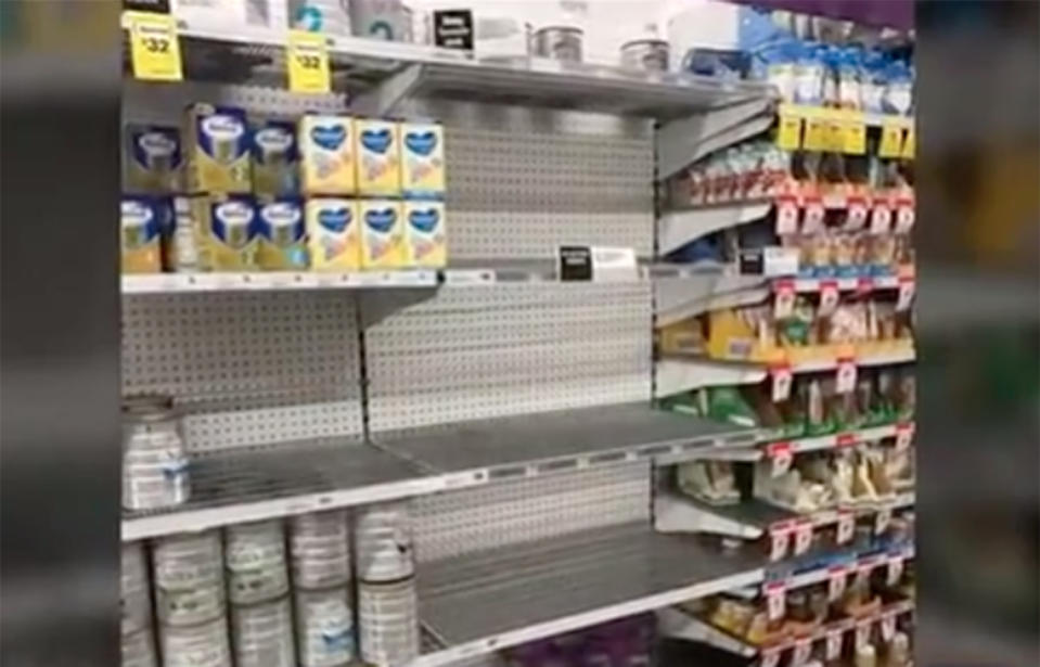 Shelves of the baby formula section are almost bare despite signs warning of strict sale limits. Source: 7 News