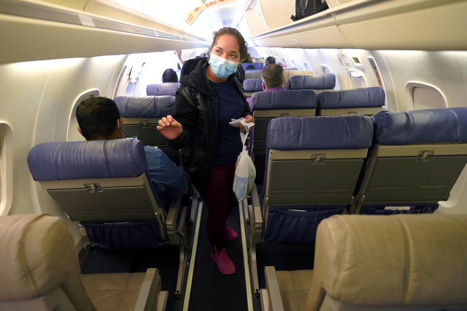 Celestina Ramirez, a migrant from Honduras, looks for her seat on a plane with her son Yancarlos Amaya, 5, at Valley International Airport, Wednesday, March 24, 2021, in Harlingen, Texas. The mother and son, who are headed to Baltimore to reunite with Ramirez's brother, wereallowed to stay in the U.S. after turning themselves in to U.S. Customs and Border Protection upon crossing the border. (AP Photo/Julio Cortez)