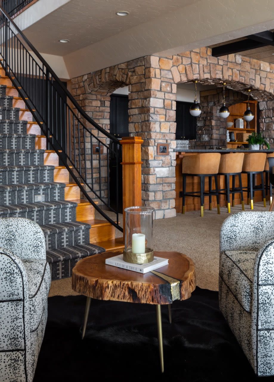 a room with a staircase and a table with chairs