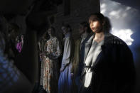 Models stand backstage waiting to display the collection "Loom by Rodina" by Russian designer Svetlana Rodina at the historical Kitai-Gorod (China Town) Wall during the Fashion Week at Zaryadye Park near Red Square in Moscow, Russia, Wednesday, June 22, 2022. (AP Photo/Alexander Zemlianichenko)