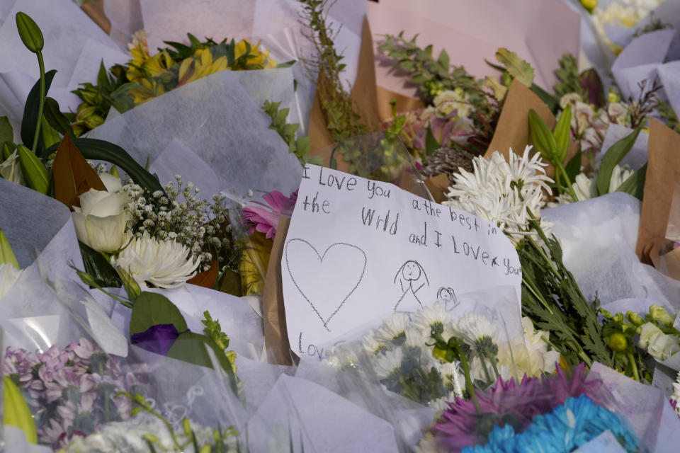 A note is attached to flowers at a tribute near a crime scene at Bondi Junction in Sydney, Monday, April 15, 2024, after several people were stabbed to death at a shopping, Saturday April 13. Australian police are examining why a lone assailant who stabbed multiple people to death in a busy Sydney shopping mall and injured more than a dozen others targeted women while avoiding men. (AP Photo/Mark Baker)