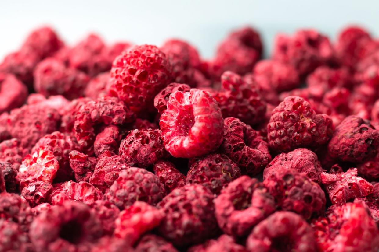 Heap of freeze dried raspberries close-up.