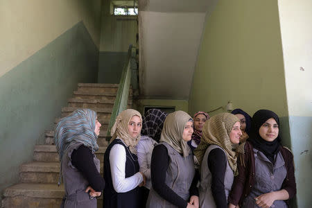 Pupils stand outside their classroom at an elementary school in eastern Mosul, Iraq, April 17, 2017. REUTERS/Marko Djurica