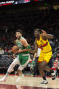 Boston Celtics forward Jayson Tatum (0) dribbles past Atlanta Hawks center Clint Capela (15) during the first half of an NBA basketball game Friday, Jan. 28, 2022, in Atlanta. (AP Photo/Hakim Wright Sr.)