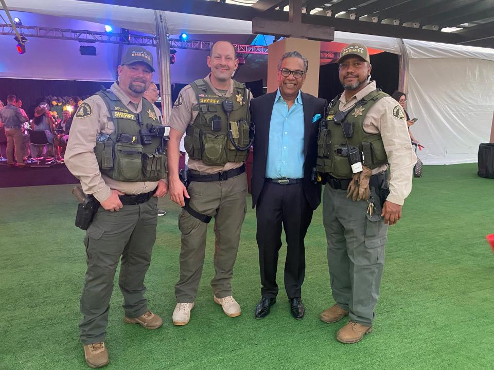Event sponsor Raju Mehta of El Paseo Jewelers looks pleased to have Riverside County Sheriff officers Nelson, Lt. Willison and Potter on hand in case someone tries to make off with the goods.