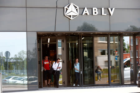 People leave ABLV bank main office building in Riga, Latvia May 23, 2018. REUTERS/Ints Kalnins