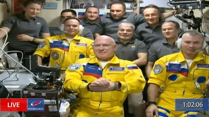 In this frame grab from video provided by Roscosmos, Russian cosmonauts Sergey Korsakov, Oleg Artemyev and Denis Matveyev are seen during a welcome ceremony after arriving at the International Space Station, Friday, March 18, 2022, the first new faces in space since the start of Russia&#x002019;s war in Ukraine. The crew emerged from the Soyuz capsule wearing yellow flight suits with blue stripes, the colors of the Ukrainian flag.