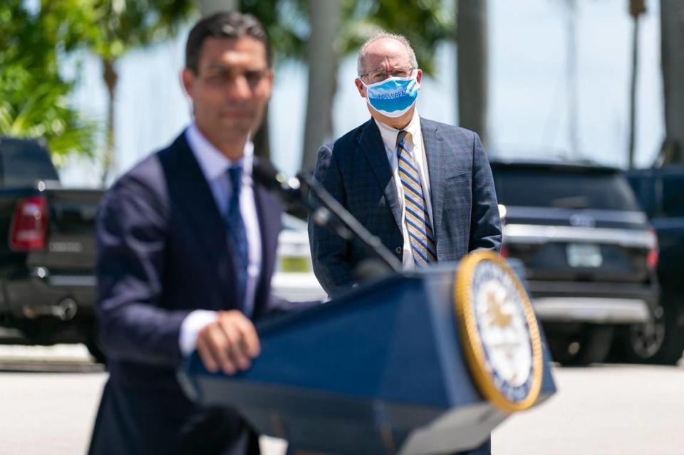 Miami Beach Mayor Dan Gelber listens as City of Miami Mayor Francis Suarez speaks during a COVID-19 press conference outside of Miami City Hall in Coconut Grove, Florida, on Monday, June 22, 2020. A total of 15 Miami-Dade mayors gathered to announce stricter enforcement of COVID-19 rules across the county.