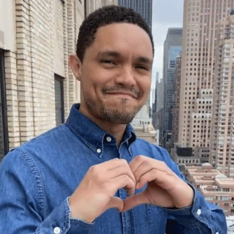 Trevor Noah on "The Daily Show" making a heart with his hands