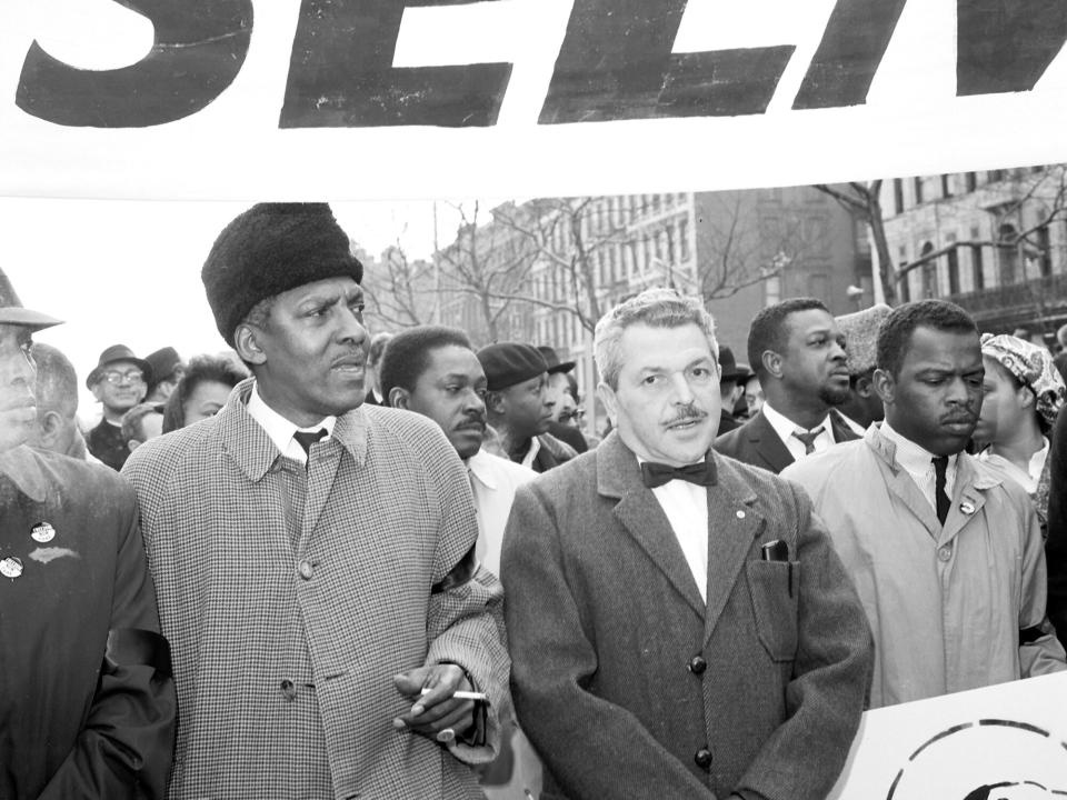 Bayard Rustin marches with Nathan Schwerner (right), father