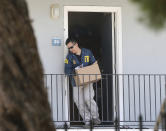 FILE - In this Aug. 15, 2018, file photo, an FBI agent removes items from an apartment following the arrest of Omar Ameen in Sacramento, Calif. A federal judge in California refused Wednesday, April 21, 2021, to allow the extradition to Iraq of Ameen, accused of killing for the Islamic State, saying cellphone evidence shows he was in Turkey at the time of the slaying. The U.S. Justice Department has tried since 2018 to return Omar Abdulsattar Ameen to Iraq under a treaty with that nation. (AP Photo/Rich Pedroncelli, File)