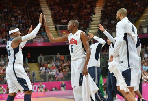 US forward Carmelo Anthony (L) and US forward Kevin Durant react during the men's preliminary round basketball match USA vs Nigeria of the London 2012 Olympic Games at the basketball arena in London. The United States team of NBA stars set a record for most points in a single Olympic men's basketball game by defeating Nigeria 156-73 on Thursday in a preliminary round game