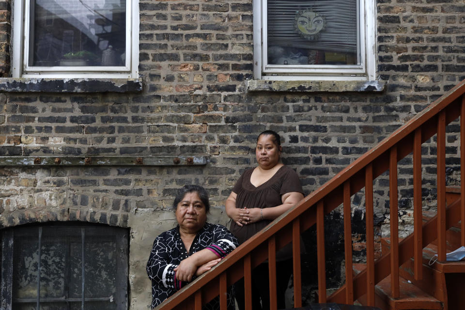 Maria Elena Estamilla, 62, left and her daughter Esmeralda Triquiz pose for a photo June 30, 2021, in Chicago's Pilsen neighborhood. Estamilla's last full medical exam was in 2015 and she sees no options for care as a Mexican immigrant without legal permission to live in the U.S. She's not eligible for Medicare, Medicaid or Affordable Care Act coverage. As a child care worker, she didn't have employer coverage and can't afford private insurance. (AP Photo/Shafkat Anowar)