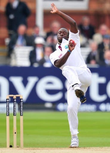 West Indies' cricketer Kemar Roach bowls during the fifth day of the first Test match against England at Lords cricket ground in London. Alastair Cook's unbeaten fifty steadied England in their victory chase after the West Indies gave the hosts a couple of scares