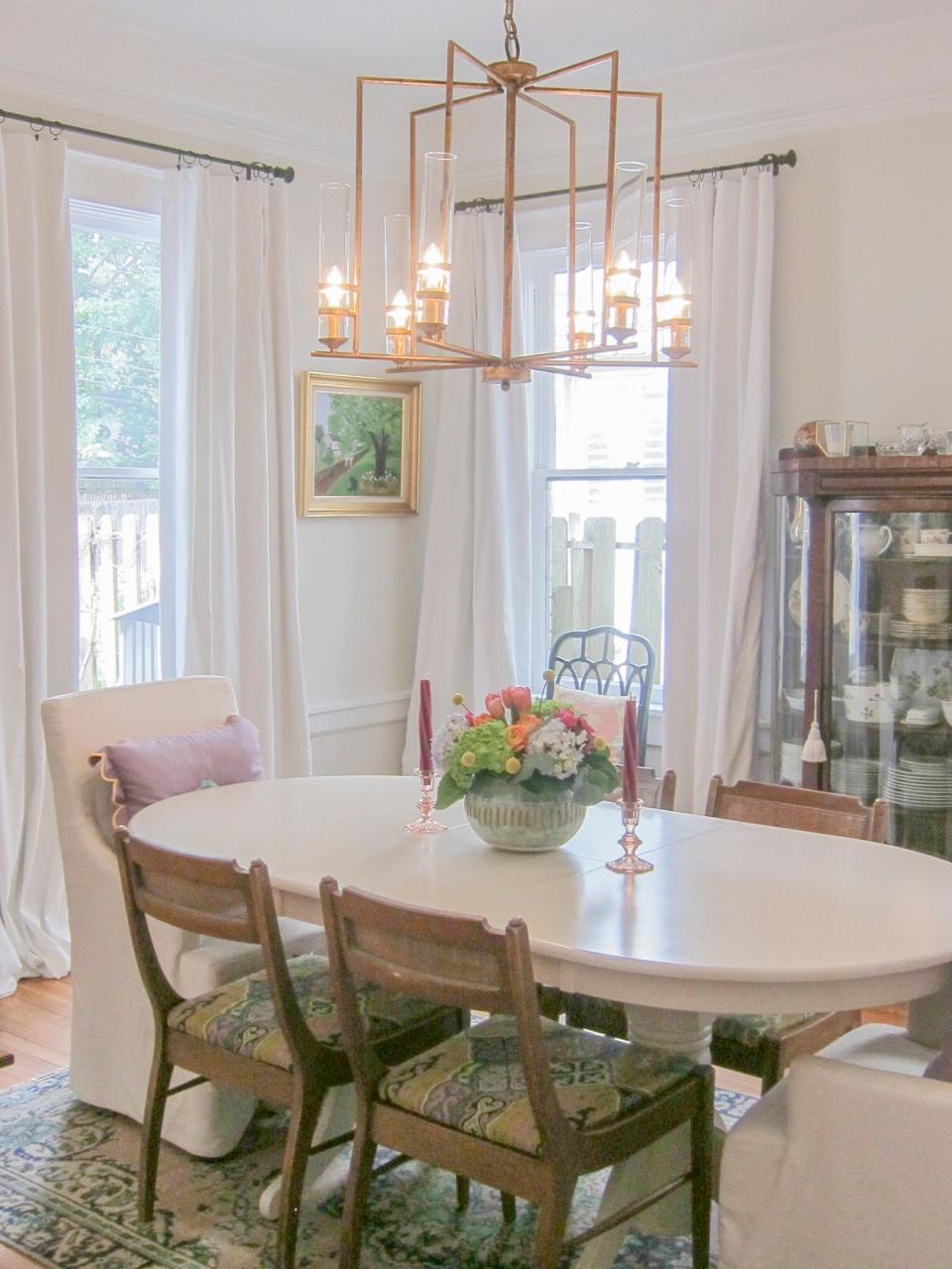 The dining room sports a mix of antiques coupled with new lighting.