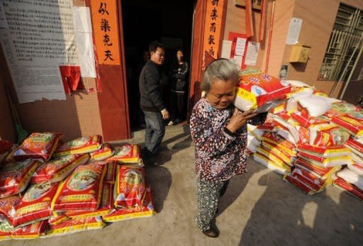 A resident collects a bag of rice from the provisional village commitee in Wukan, a fishing village in the southern province of Guangdong, southern China. Protesters from the village say they will march on government offices this week unless the body of a local leader is released and four villagers in police custody are freed