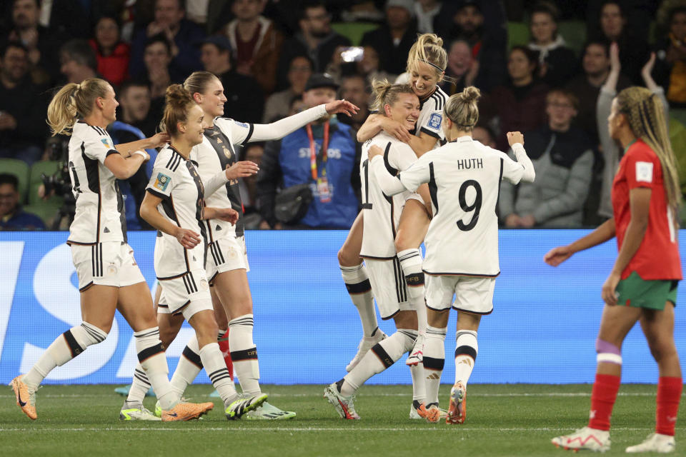 Germany players celebrate after Germany's Alexandra Popp, 4th right, scored the opening goal during the Women's World Cup Group H soccer match between Germany and Morocco in Melbourne, Australia, Monday, July 24, 2023. (AP Photo/Hamish Blair)