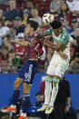 Austin FC defender Julio Cascante (18) and FC Dallas forward Petar Musa (9) jump for a header during the first half of an MLS soccer match Saturday, May 11, 2024, in Frisco, Texas. (AP Photo/LM Otero)