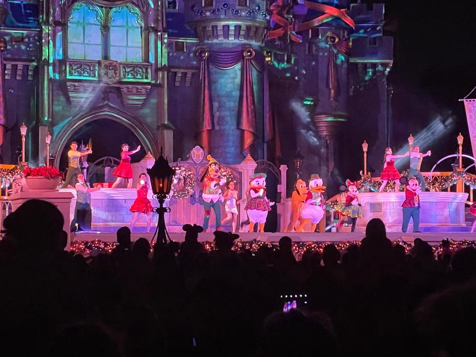 christmas-themed castle stage show at mickey's very merry christmas party in magic kingdom