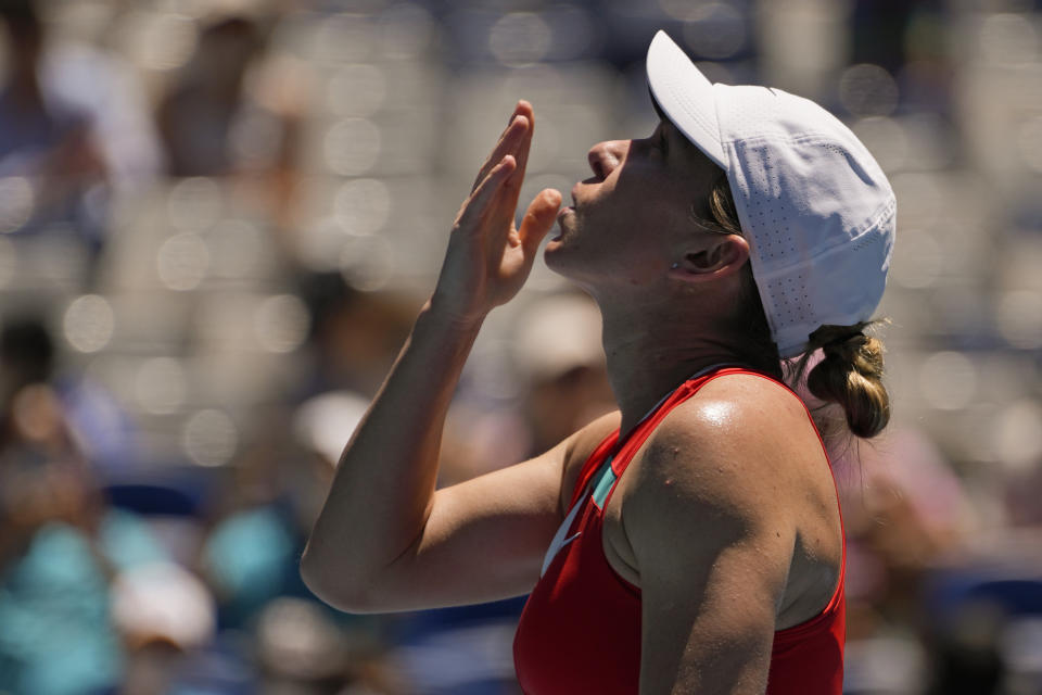 Simona Halep of Romania reacts after defeating Danka Kovinic of Montenegro in their third round match at the Australian Open tennis championships in Melbourne, Australia, Saturday, Jan. 22, 2022. (AP Photo/Simon Baker)