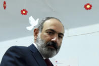 Acting Armenian Prime Minister Nikol Pashinyan looks at a photographer after voting at a polling station during a parliamentary elections in Yerevan, Armenia, Sunday, June 20, 2021. Armenians are voting in a national election after months of tensions over last year's defeat in fighting against Azerbaijan over the separatist region of Nagorno-Karabakh. (Lusi Sargsyan/PHOTOLURE via AP)