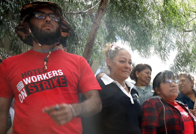 SANTA MONICA, CA - OCTOBER 23, 2023 - Venezuelan migrant Sebastian Atencio, 34, left, joins members of UNITE HERE Local 11 at a press conference alleging that refugee workers are using a dodgy agency to provide houseless strikebreakers to work at Le Meridien Defina hotel in Santa Monica on October 23, 2023. Atencio was hired to work at Le Meridien Defina on Sept. 26. He said he was given a large workload and forced to work without breaks. (Genaro Molina / Los Angeles Times)