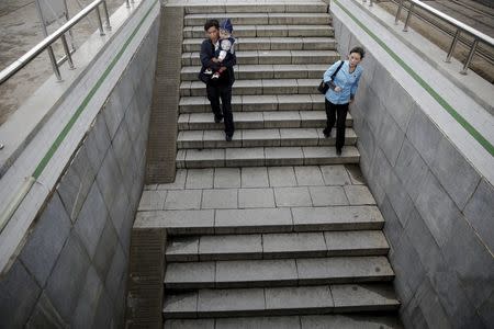 People enter an underground crossing in central Pyongyang October 11, 2015. REUTERS/Damir Sagolj