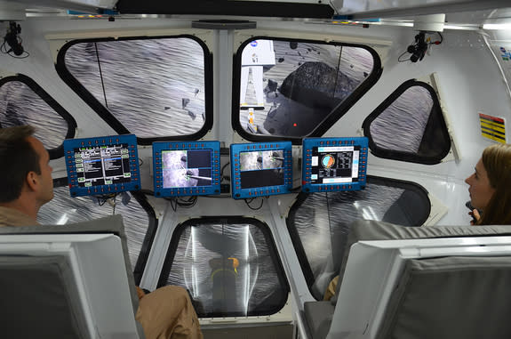 : Scientist Liz Rampe and flight controller David Coan pilot NASA’s multi-mission Space Exploration Vehicle (SEV) during an asteroid mission simulation at the Johnson Space Center in Houston, Aug. 30, 2012.