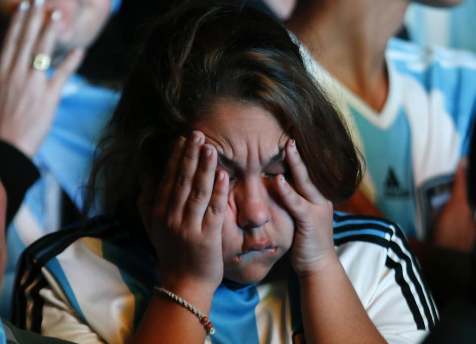 An Argentina fan reacts after Argentina lost to Germany in their 2014 World Cup final soccer match in Brazil, at a public square viewing area in Buenos Aires, July 13, 2014. REUTERS/Ivan Alvarado (ARGENTINA - Tags: SPORT SOCCER WORLD CUP TPX IMAGES OF THE DAY)