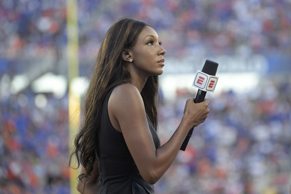 FILE - In this Aug. 24, 2019, file photo, ESPN's Maria Taylor works from the sideline during the first half of an NCAA college football game between Miami and Florida in Orlando, Fla. Taylor is leaving ESPN after the two sides were unable to reach an agreement on a contract extension. Taylor had been with ESPN since 2014 but her contract expired Tuesday, July 20, 2021. Her last assignment for the network was Tuesday night at the NBA Finals, where she was the pregame and postgame host for the network's “NBA Countdown” show. (AP Photo/Phelan M. Ebenhack, File)