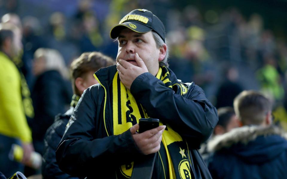 <p>A Borussia Dortmund fan looks concerned at the Signal Iduna Park. </p>