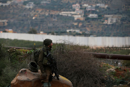 FILE PHOTO: FILE PHOTO: An Israeli soldier guards near the border with Lebanon, the morning after the Israeli military said it had launched an operation to "expose and thwart" cross-border attack tunnels from Lebanon, in Israel's northernmost town Metula December 5, 2018. REUTERS/Ronen Zvulun/File Photo/File Photo