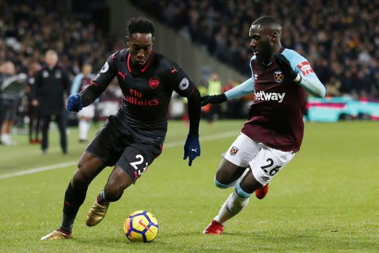 Arsenal's Danny Welbeck (L) vies with West Ham United's Arthur Masuaku during their match in east London on December 13, 2017