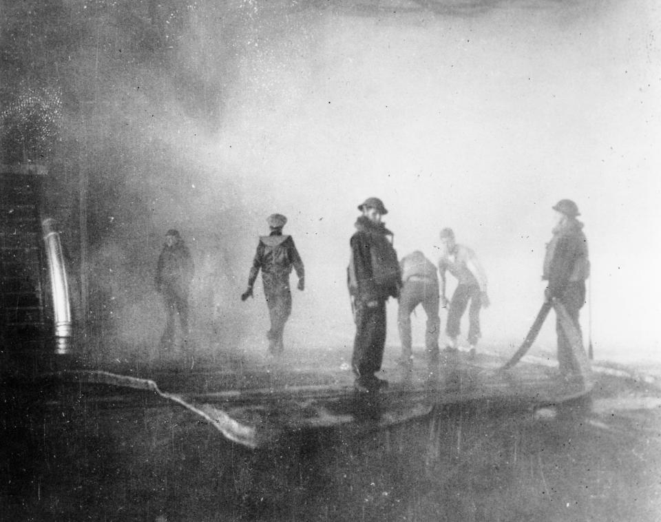 FILE - In this June 4, 1942 file photo crewmen aboard the USS Yorktown battle fire after the carrier was hit by Japanese bombs, during the Battle of Midway. Later the vessel had to be abandoned and was sunk by a Japanese submarine torpedo hit. A group of deep-sea explorers scouring the world's oceans for sunken World War II ships is honing in on sonar readings of debris fields in the Pacific Ocean. A research vessel called the Petrel is launching underwater robots about halfway between the U.S. and Japan in search of warships from the Battle of Midway. (AP Photo, File)