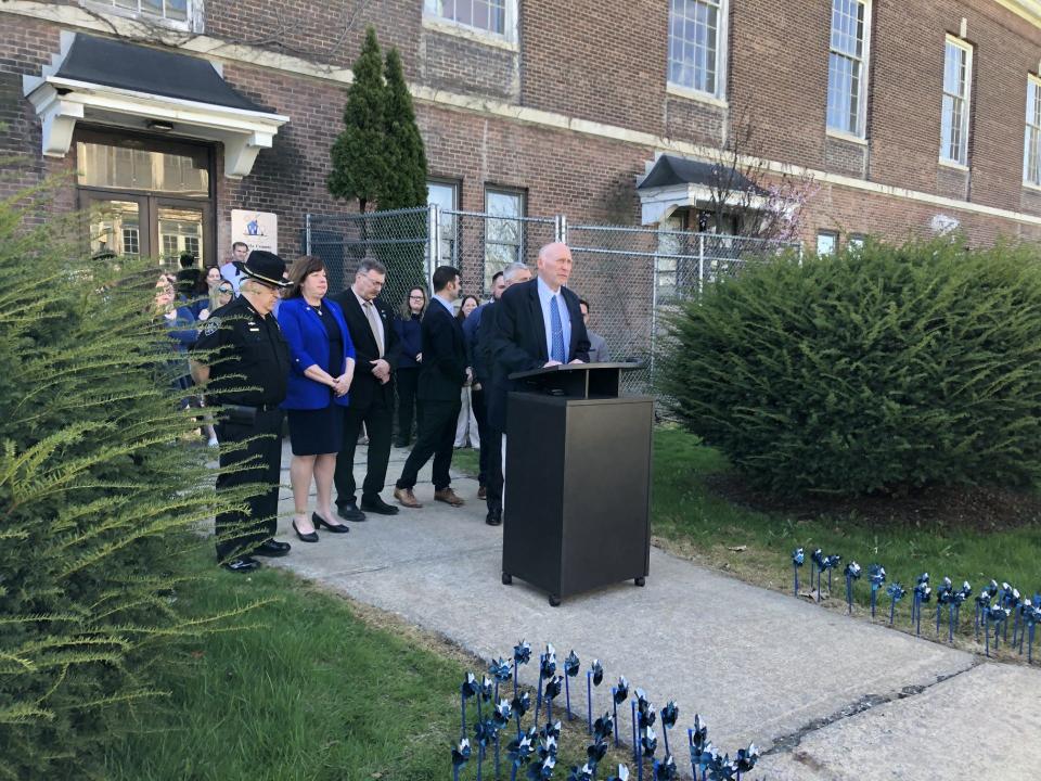 Chief Deputy Derrick O'Meara, director of the Oneida County Child Advocacy Center, stands in front of a group of elected officials and staff from local agencies to address a press conference outside the advocacy center on Tuesday, April 23, 2024 to mark Child Abuse Prevention Month. Pinwheels are "planted" each April to mark the month and to symbolize the healthy, happy childhoods all kids should experience.