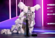 <p>The star performed multiple outfit changes throughout the evening to perform and accept her numerous award wins, including this shimmering silver bodysuit and white feather cape, from the recent Valentino couture collection.</p>