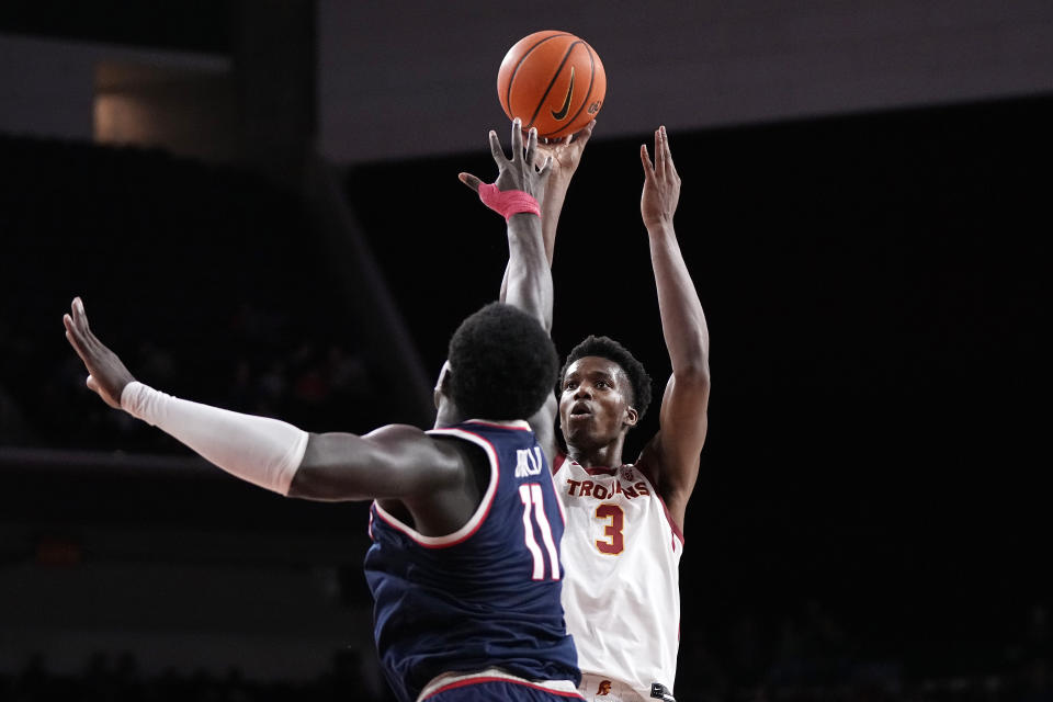 Southern California forward VIncent Iwuchukwu, right, shoots as Arizona center Oumar Ballo defends during the second half of an NCAA college basketball game Thursday, March 2, 2023, in Los Angeles. (AP Photo/Mark J. Terrill)