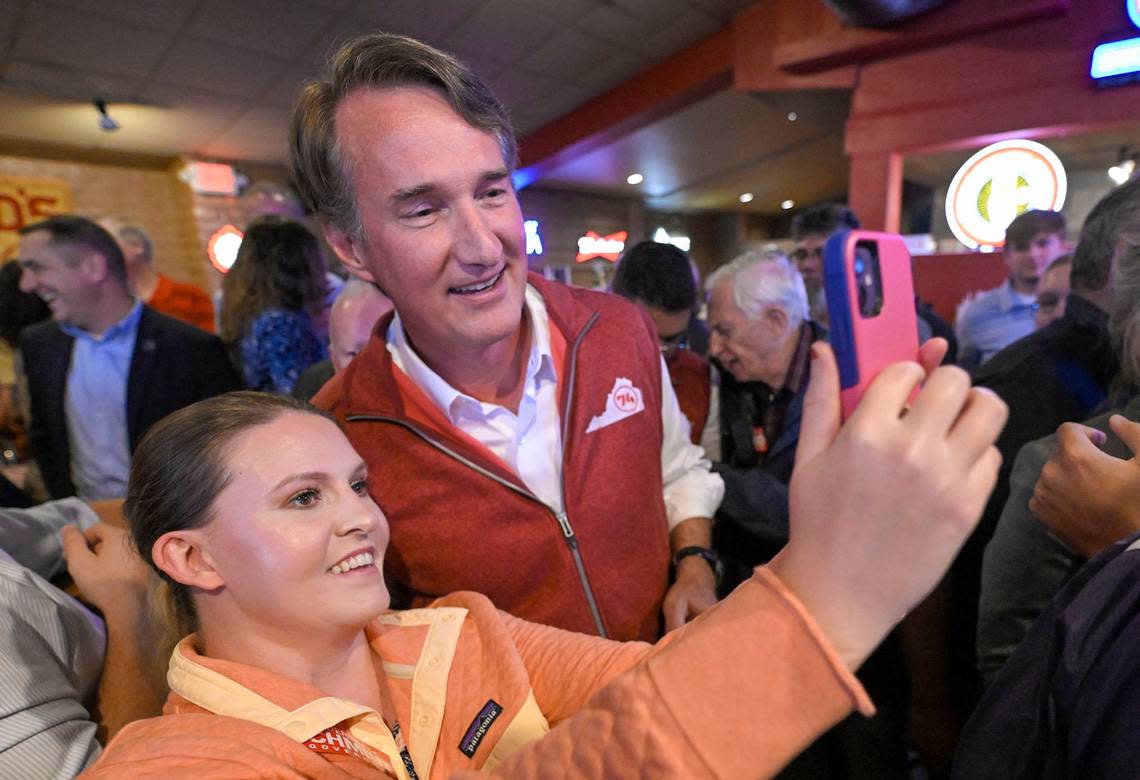 Virginia Governor Glenn Youngkin, second from left, took photos with supporters at a campaign event for Kansas Attorney General Derek Schmidt, the Republican nominee for Governor, on Thursday, Sept. 22, 2022, at Hayward’s Pit Bar B Que in Shawnee. The event was hosted by the Kansas Republican Party.