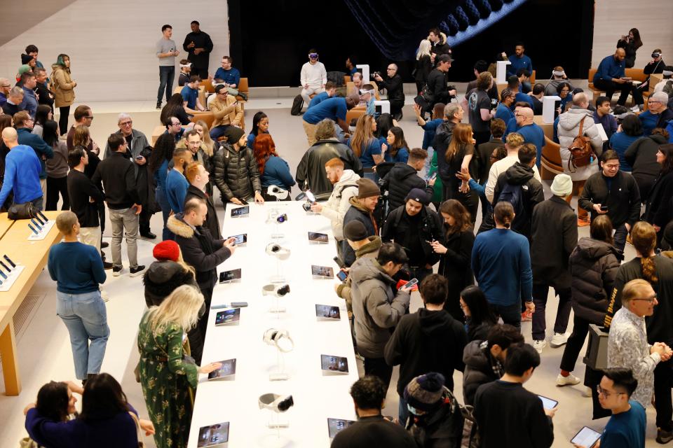 a large crowd of people inside an Apple Store in Manhattan for the launch of the Apple Vision Pro