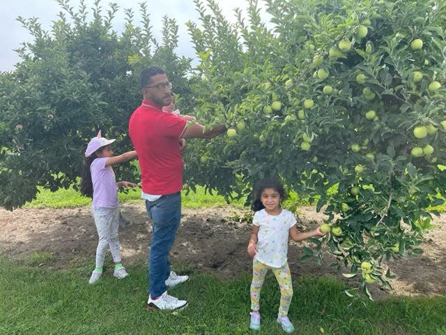 Yousef Abu Jenna Mahmoud, of Ann Arbor, with his three children at Erie Orchards and Cider Mills in Monroe County in Erie, Michigan, on August 13, 2013. He alleges he and his family were threatened and racially harassed with anti-Muslim comments by  the owner, who is heard on a video saying: "Every Muslim that comes in here steals from me."