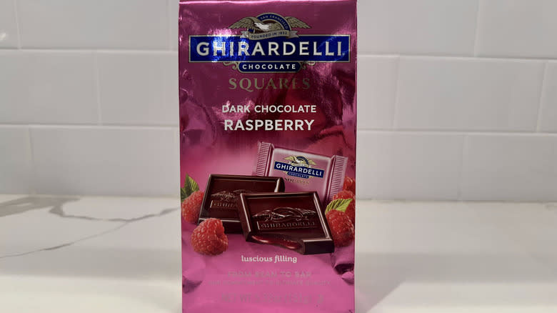 Dark chocolate raspberry squares on counter