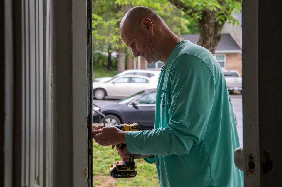 Brian Phelps with Evansville Handy Man repairs a door frame at the McGann residence in Martin Park West Friday, May 6, 2022. 